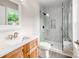 Bathroom features a shower with tile walls, a glass door, and a wood vanity at 570 Key West Ave, Kannapolis, NC 28081