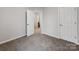 Bedroom with white walls and carpet floor, and view of adjacent bathroom at 570 Key West Ave, Kannapolis, NC 28081