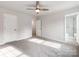 Spacious bedroom featuring carpeted flooring, ceiling fan, and an ensuite bathroom at 570 Key West Ave, Kannapolis, NC 28081