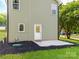 Exterior side view with patio, green lawn, and mulch at 570 Key West Ave, Kannapolis, NC 28081