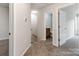 Upstairs hallway with carpeted floor with view of staircase and bathroom with gray tile at 570 Key West Ave, Kannapolis, NC 28081
