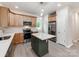 Well-lit kitchen features stainless steel appliances, wood cabinets, kitchen island, and white countertops at 570 Key West Ave, Kannapolis, NC 28081