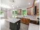 Bright kitchen with wood cabinets, quartz counters, island, and modern lighting fixtures, perfect for cooking at 570 Key West Ave, Kannapolis, NC 28081