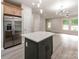 Well-designed kitchen with an island, stainless steel fridge, and open layout to living area at 570 Key West Ave, Kannapolis, NC 28081