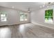 Bright, airy living room with large windows, modern ceiling fan, and resilient, stylish flooring at 570 Key West Ave, Kannapolis, NC 28081