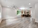 Spacious, light-filled living room with modern ceiling fan, neutral walls, and durable wood-look floors at 570 Key West Ave, Kannapolis, NC 28081