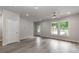 Inviting living room featuring large windows, ceiling fan, neutral paint, and elegant flooring at 570 Key West Ave, Kannapolis, NC 28081