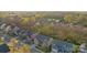 Aerial view of a neighborhood showcasing well-maintained homes, tree-lined streets, and a serene pond at 6004 Clover Hill Rd, Indian Trail, NC 28079