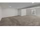Spacious unfinished basement with neutral carpeting and recessed lighting, offering potential for customization at 6004 Clover Hill Rd, Indian Trail, NC 28079
