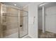 Stylish bathroom featuring a glass-enclosed shower with tiled walls and a convenient towel rack at 6004 Clover Hill Rd, Indian Trail, NC 28079