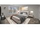 Well-lit bedroom with plush bedding and decorative artwork at 6004 Clover Hill Rd, Indian Trail, NC 28079