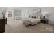 Spacious and well-lit Primary bedroom features carpet floors, a large window, and modern decor at 6004 Clover Hill Rd, Indian Trail, NC 28079