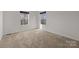 Spacious carpeted bedroom with natural light coming through windows offers a cozy atmosphere at 6004 Clover Hill Rd, Indian Trail, NC 28079