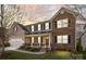 Inviting two-story home showcasing a stone facade, covered porch, and well-manicured landscaping at 6004 Clover Hill Rd, Indian Trail, NC 28079