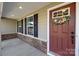 Charming front entrance with a decorative wreath, sidelights, and stone accents, creating a welcoming appeal at 6004 Clover Hill Rd, Indian Trail, NC 28079