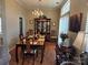 Spacious dining room featuring an ornate chandelier, hardwood floors, and lots of light at 8411 Rhian Brook Ln, Charlotte, NC 28216