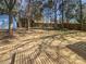 Large backyard with mature trees and a wooden deck perfect for outdoor relaxation at 10707 Copper Field Dr, Pineville, NC 28134