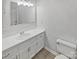 Bathroom showcasing white fixtures, a well-lit mirror, and ample vanity space at 10707 Copper Field Dr, Pineville, NC 28134