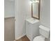 Cozy bathroom featuring a vanity sink with a classic mirror and toilet at 10707 Copper Field Dr, Pineville, NC 28134