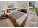 Comfortable bedroom featuring a wooden bed frame, soft textures, and calming decor at 10707 Copper Field Dr, Pineville, NC 28134