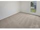 This bedroom has carpet flooring and a window overlooking the front yard at 10707 Copper Field Dr, Pineville, NC 28134