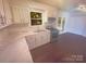 Modern kitchen with updated countertops, stainless steel appliances, and bright white cabinets at 10707 Copper Field Dr, Pineville, NC 28134