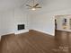 Open living room boasts hardwood floors and a brick fireplace, perfect for entertaining at 10707 Copper Field Dr, Pineville, NC 28134