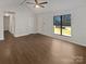 Bright and spacious living room with hardwood flooring and a large window at 10707 Copper Field Dr, Pineville, NC 28134