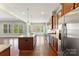 Modern kitchen features an island with granite countertops and stainless steel appliances at 11037 Thornbeck Ln, Midland, NC 28107