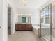 Bright bathroom with a soaking tub, a glass-enclosed shower, and double vanities at 11037 Thornbeck Ln, Midland, NC 28107