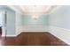 Formal dining room featuring hardwood floors, wainscoting, and a chandelier at 11037 Thornbeck Ln, Midland, NC 28107