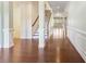 A spacious foyer features dark wood floors, white columns, and staircase to the second floor at 11037 Thornbeck Ln, Midland, NC 28107