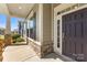The front porch features stone accents, a dark front door, and large windows at 11037 Thornbeck Ln, Midland, NC 28107