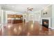 Open-concept living space includes a modern kitchen, hardwood floors, fireplace, and adjoining rooms at 11037 Thornbeck Ln, Midland, NC 28107