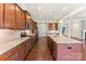 A bright kitchen features stainless steel appliances, a large island, and granite countertops at 11037 Thornbeck Ln, Midland, NC 28107