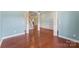 An open concept living room features white columns and dark wood floors throughout at 11037 Thornbeck Ln, Midland, NC 28107