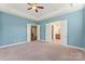 A spacious main bedroom boasts a ceiling fan, tray ceilings and ensuite bath and closet doors at 11037 Thornbeck Ln, Midland, NC 28107