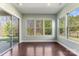 Bright sunroom with wood floors, and large windows offering backyard views and natural light at 11037 Thornbeck Ln, Midland, NC 28107