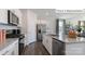 Bright kitchen featuring stainless steel appliances, white cabinets, granite countertops, and a breakfast bar at 2048 Harlequin Dr, Indian Trail, NC 28079
