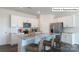 Well-lit kitchen featuring white cabinets, granite countertops, stainless steel appliances, and barstool seating at 2048 Harlequin Dr, Indian Trail, NC 28079