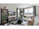 Cozy living room with a white sofa, stylish decor, and large windows with striped curtains at 2048 Harlequin Dr, Indian Trail, NC 28079