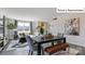 Open-concept living room featuring a modern sofa, patterned rug, and lots of natural light at 2048 Harlequin Dr, Indian Trail, NC 28079