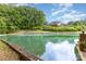 Scenic view of a lake and backyard with lush greenery and a waterfront deck at 3004 Vernell Ln, Shelby, NC 28150
