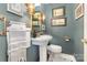 Chic powder room with pedestal sink, stylish lighting, and decorative artwork at 3004 Vernell Ln, Shelby, NC 28150