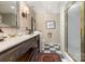 Elegant bathroom with wood accents, double sinks, and glass shower, offering a spa-like retreat at 3004 Vernell Ln, Shelby, NC 28150