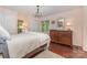 Charming bedroom with wood floors, dresser, and decorative mirror creating a cozy atmosphere at 3004 Vernell Ln, Shelby, NC 28150
