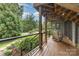 Inviting deck with wooden railing and comfortable seating, offering a serene outdoor space surrounded by trees at 3004 Vernell Ln, Shelby, NC 28150