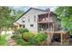 Grey house with multi-level decks, lush landscaping, and a brick walkway, blending beauty with nature at 3004 Vernell Ln, Shelby, NC 28150