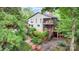 Multi-level decks accent this beautiful grey home surrounded by lush landscaping and brick walkways at 3004 Vernell Ln, Shelby, NC 28150