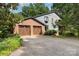 Exterior view of home with two-car garage, brick accents, and a spacious driveway at 3004 Vernell Ln, Shelby, NC 28150